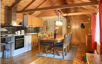 a kitchen with a wooden table and chairs at 3 Bedroom Amazing Home In Haddal in Haddal