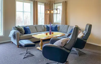 a living room with a couch and chairs and a table at 3 Bedroom Amazing Home In Haddal in Haddal
