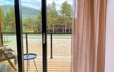 a room with a window with a view of a river at 2 Bedroom Gorgeous Home In Bjorli in Bjorli