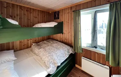 a bedroom with two bunk beds and a window at Nice Home In Nord-Torpa With Sauna in Nord Torpa