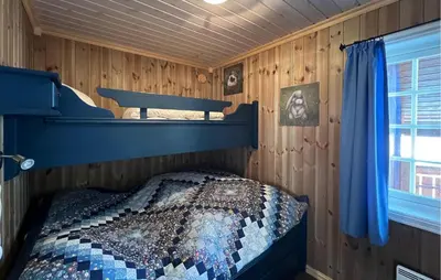 a bedroom with a bunk bed in a wooden cabin at Nice Home In Nord-Torpa With Sauna in Nord Torpa