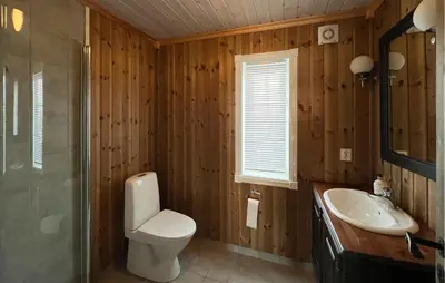 a bathroom with a toilet and a sink at Nice Home In Nord-Torpa With Sauna in Nord Torpa