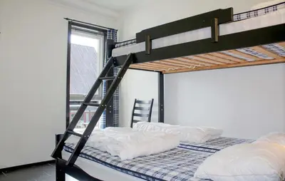 two bunk beds in a room with a ladder at Lovely Apartment In Hemsedal With Sauna in Hemsedal