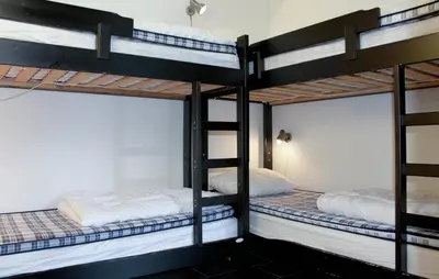 two bunk beds in a dorm room with white walls at Lovely Apartment In Hemsedal With Sauna in Hemsedal