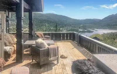 a balcony with a view of a river and mountains at Nice Home In Rjukan With Wifi in Rjukan