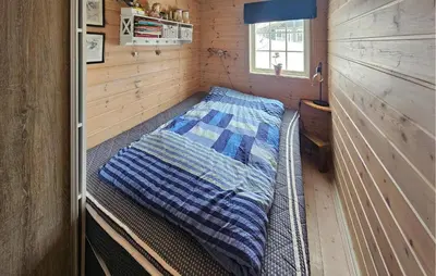 a bed in a small room in a tiny house at Nice Home In Rjukan With Wifi in Rjukan