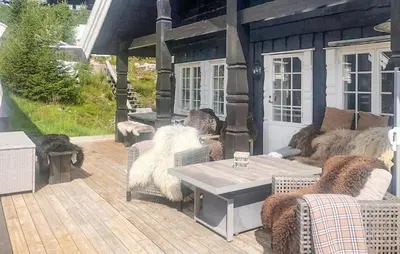 a patio with couches and a table on a deck at Nice Home In Rjukan With Wifi in Rjukan