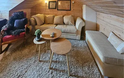 a living room with a couch and two tables at Nice Home In Rjukan With Wifi in Rjukan
