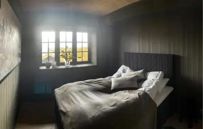 a bedroom with a bed with pillows and a window at Stunning Apartment In Hovden I Setesdal in Hovden