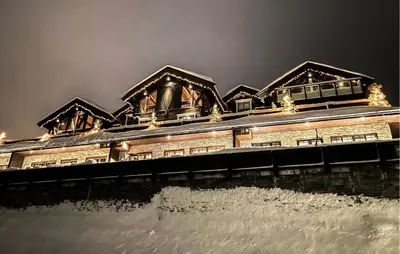 a building with snow on the roof at night at Stunning Apartment In Hovden I Setesdal in Hovden