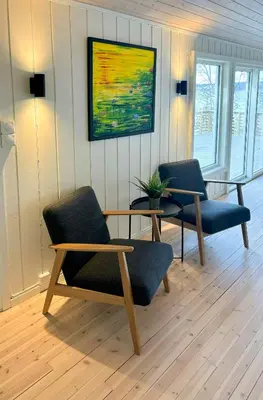 a living room with two chairs and a table at Cabin By Lake Tyrifjorden With Water Views