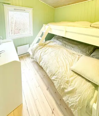a bedroom with a bunk bed and a wooden floor at Cabin By Lake Tyrifjorden With Water Views