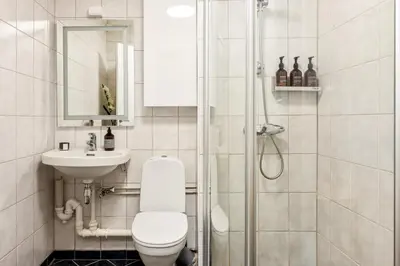 a bathroom with a toilet and a sink and a shower at Modern Suites, Excellent Location in the heart of Bergen in Bergen