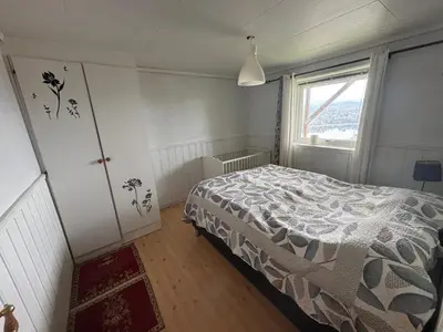 a bedroom with a bed and a window at Utsiken in Bergen