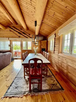 a dining room with a table and chairs at Traditional mountain cabin in Valdres in Blomstølen