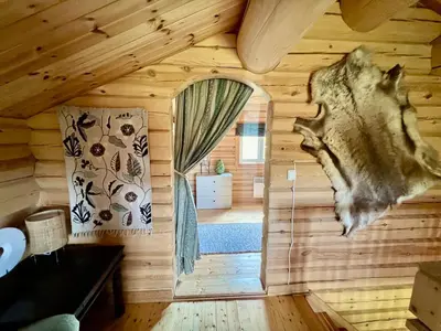 a log cabin with a bedroom and a window at Traditional mountain cabin in Valdres in Blomstølen