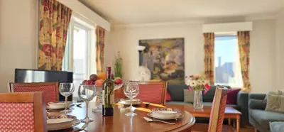 a dining room with a table with wine glasses at Midt i byn in Bergen