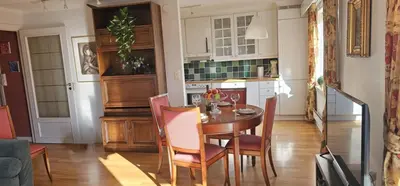 a kitchen with a table and chairs in a room at Midt i byn in Bergen