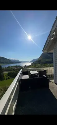 a view of the ocean from a house balcony at Leiligheit i Hornindal in Volda