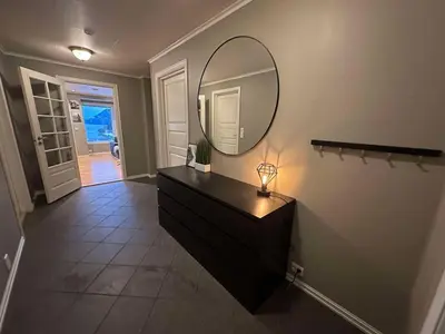 a bathroom with a black dresser and a mirror at Leiligheit i Hornindal in Volda