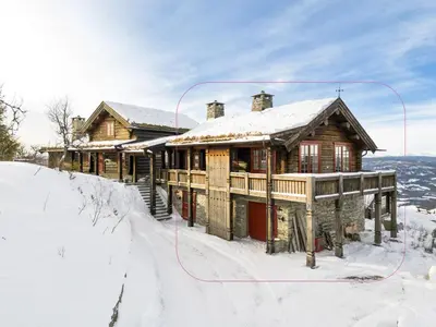 a log cabin in the snow with a snow hose at Tømmerhytte i Valdres med panoramautsikt over fjellene in Aurdal
