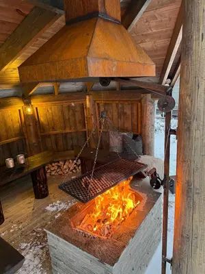 an open oven with a grill over a fire at Vacation house in Hemsedal in Hemsedal