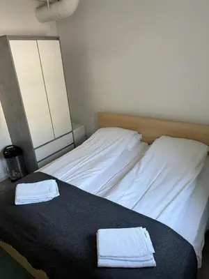 a bed with two towels on top of it at Sentral fantastisk leilighet in Øvre Årdal