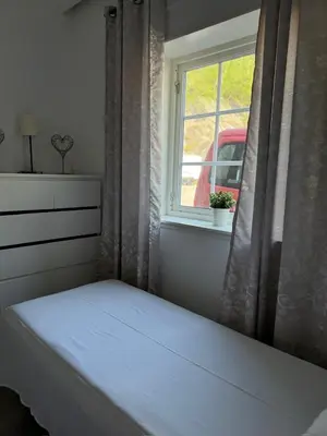 a bedroom with a bed and a window at Sentral fantastisk leilighet in Øvre Årdal