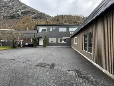 a parking lot in front of a house at Sentral fantastisk leilighet in Øvre Årdal