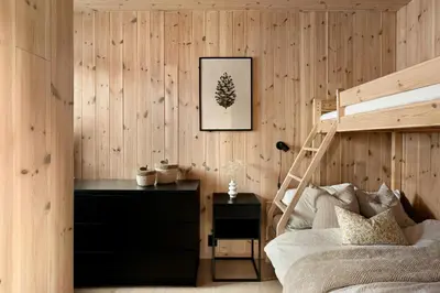 a bedroom with a bunk bed and a desk at Cabin Overlooking Ryfylke Fjord in Høyvik