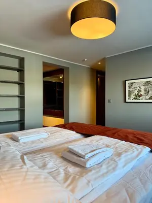 a bedroom with a large bed with towels on it at Geilolie - apartment in Geilo in Geilo