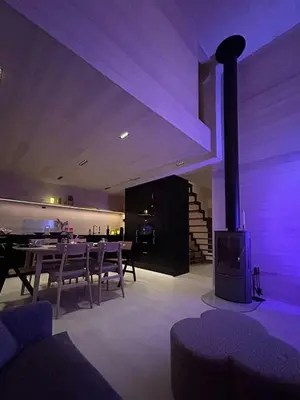 a dining room with a fireplace and a table and chairs at Modern Cabin With A Personal Touch in Sogndal