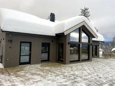 a house with a roof covered in snow at Veltelia Resort in Nes i Ådal