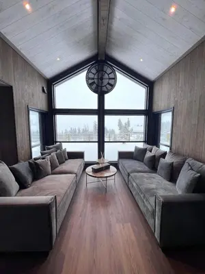 a large living room with a large couch and a table at Veltelia Resort in Nes i Ådal