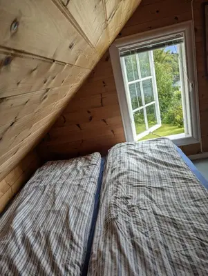 a bed in a room with a window at Charming guest house with amazing view in Kvam