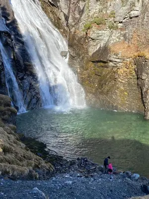 two people standing in front of a waterfall at Faleide View in Stryn