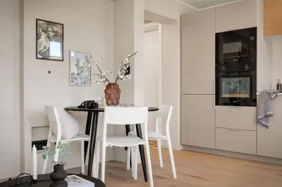 a dining room with a table and white chairs at Stay Panorama - Best view in Bergen l 1-Bedroom in Bergen