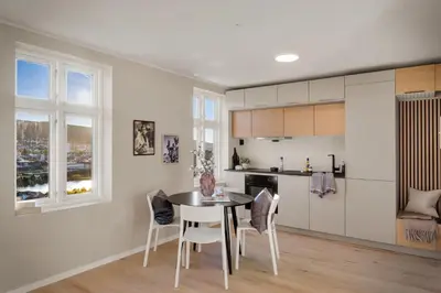 a kitchen and dining room with a table and chairs at Stay Panorama - Best view in Bergen l Studio in Bergen