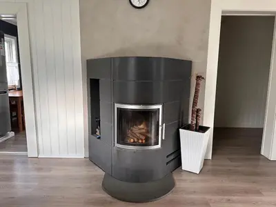 a fireplace in a living room with a fire place at Beautiful spacious home w garden in Trondheim