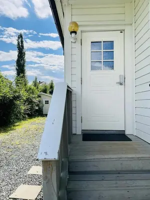 a white door on a house with a porch at Beautiful spacious home w garden in Trondheim