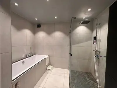 a bathroom with a bath tub and a shower at Beautiful spacious home w garden in Trondheim