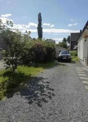 a car parked in the driveway of a house at Beautiful spacious home w garden in Trondheim