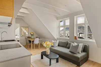 a living room with a couch and a table at Stay Panorama - Best view in Bergen l 2-Bedroom in Bergen