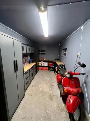 a room with a red scooter parked in a garage at Scenic Private House Surrounded by Nature in Sæbø