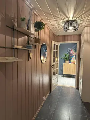 a hallway with wood paneling and a ceiling with a mirror at Scenic Private House Surrounded by Nature in Sæbø