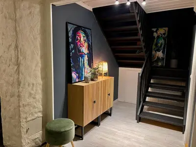 a room with a painting of a man on the wall at Scenic Private House Surrounded by Nature in Sæbø