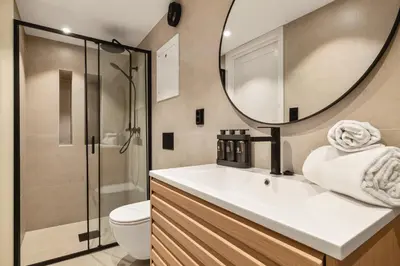 a bathroom with a sink and a toilet and a mirror at Stay Panorama - Best view in Bergen l 2BR & Terrace in Bergen