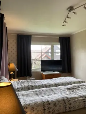 a bedroom with a large bed and a window at Short way to city centre and Aker Solutions! in Stord
