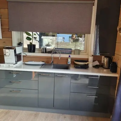 a kitchen with a sink and a window at Modern holiday home in Ålesund