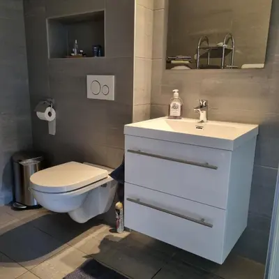 a bathroom with a white sink and a toilet at Modern holiday home in Ålesund